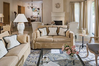 Terre Blanche Hotel and Spa Provence villa lounge sitting room with two sofas patterned rug and fireplace