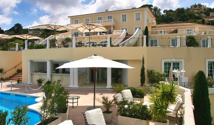 Althoff Villa Belrose Saint Tropez exterior yellow building with balconies and outdoor pool