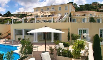 Althoff Villa Belrose Saint Tropez exterior yellow building with balconies and outdoor pool