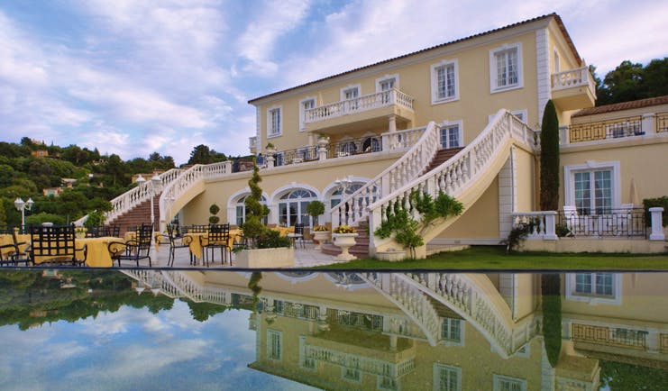 Althoff Villa Belrose Saint Tropez outdoor terrace yellow building balcony and stair cases and pool