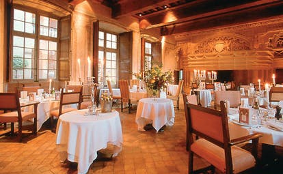 Chateau de Bagnols Rhone Valley dining room large windows shutters and fireplace