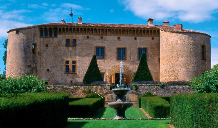 Chateau de Bagnols Rhone Valley exterior castle overlooking lawned garden and fountain