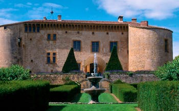 Chateau de Bagnols Rhone Valley exterior castle overlooking lawned garden and fountain