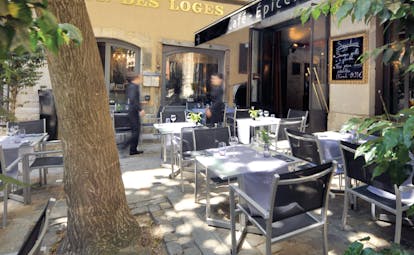 Hotel Cour des Loges Lyon cafe outdoor dining area with sign reading Cafe Epicerie