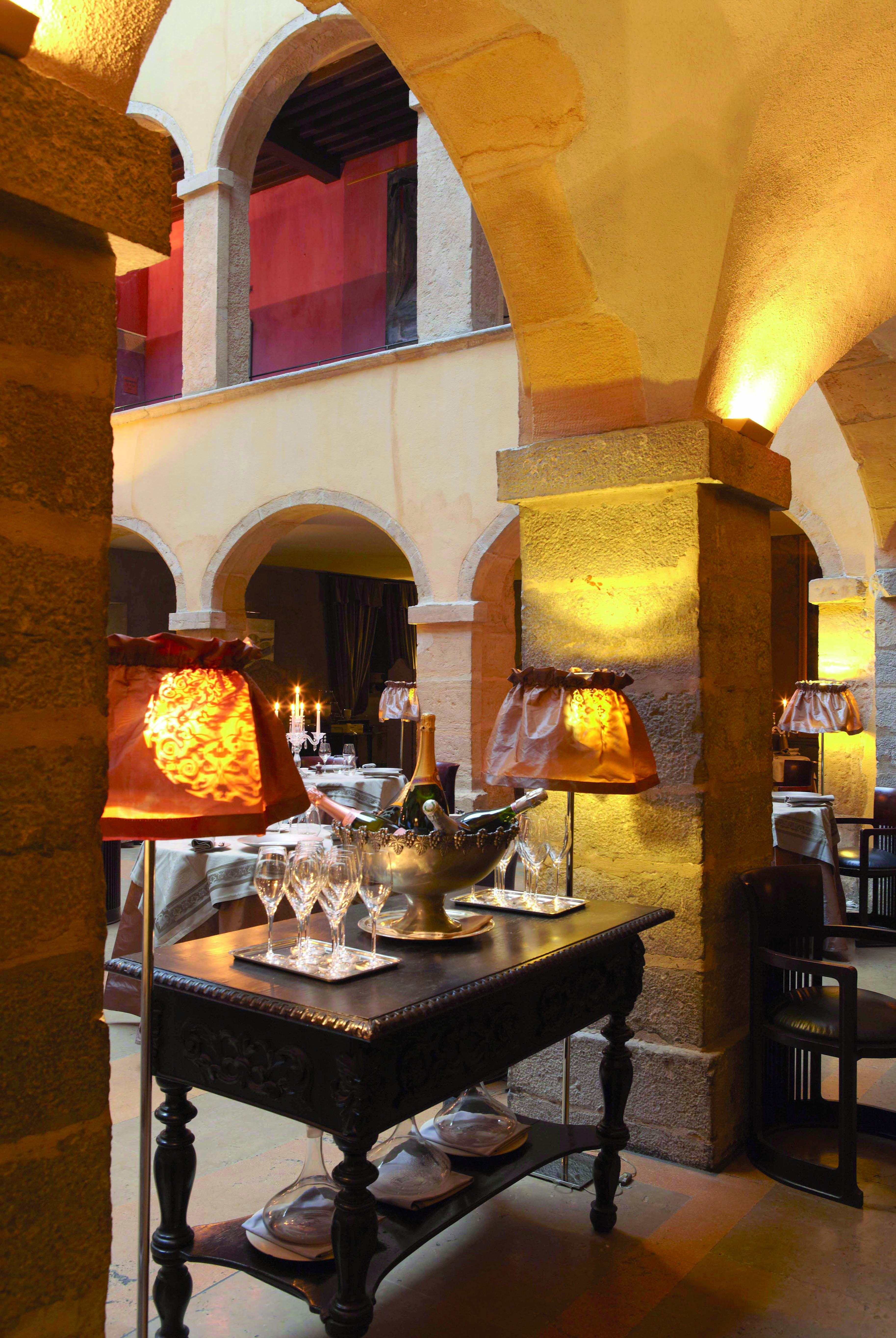 Hotel Cour des Loges Lyon restaurant dining area ornate wine cooler wine bottles and glasses
