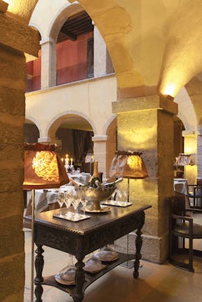 Hotel Cour des Loges Lyon restaurant dining area ornate wine cooler wine bottles and glasses
