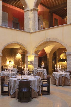 Hotel Cour des Loges Lyon restaurant dining area candelabras and archways