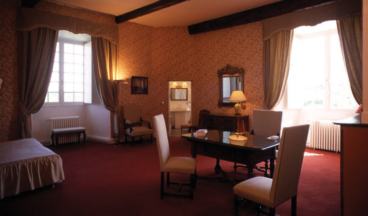 Chateau de Mercues Tarn and Lot bedroom with sitting area and view to bathroom