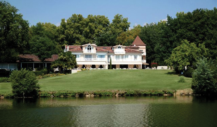 La Reserve Albi exterior river building and lawns next to a river