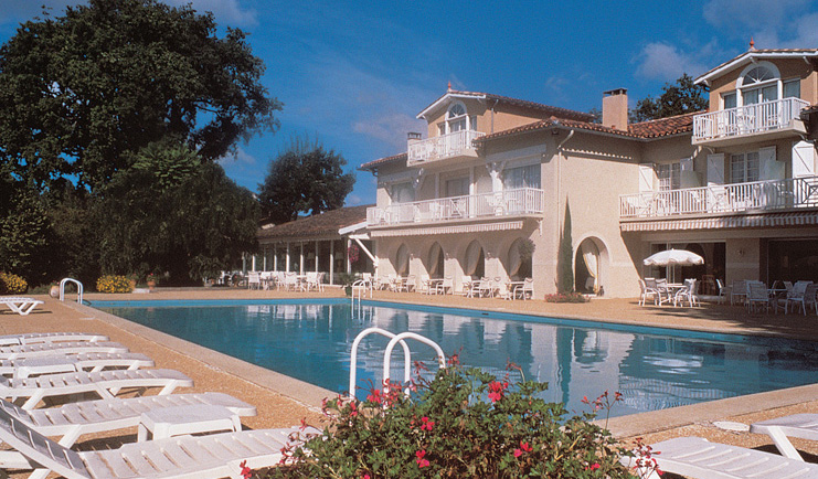 La Reserve Albi outdoor pool building with balconies overlooking outdoor pool with loungers
