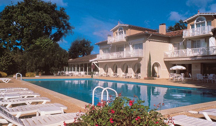 La Reserve Albi outdoor pool building with balconies overlooking outdoor pool with loungers