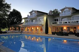 La Reserve Tarn and Lot outdoor pool two large buildings with archways and balconies