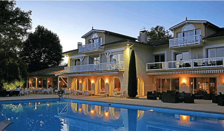 La Reserve Tarn and Lot outdoor pool two large buildings with archways and balconies