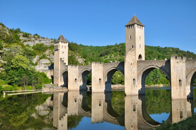 Medieval bridge with arches and turrets over river Lot at Cahors