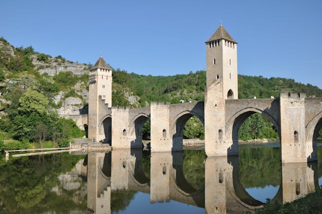 Medieval bridge with arches and turrets over river Lot at Cahors