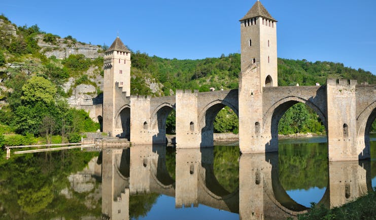 Medieval bridge with arches and turrets over river Lot at Cahors