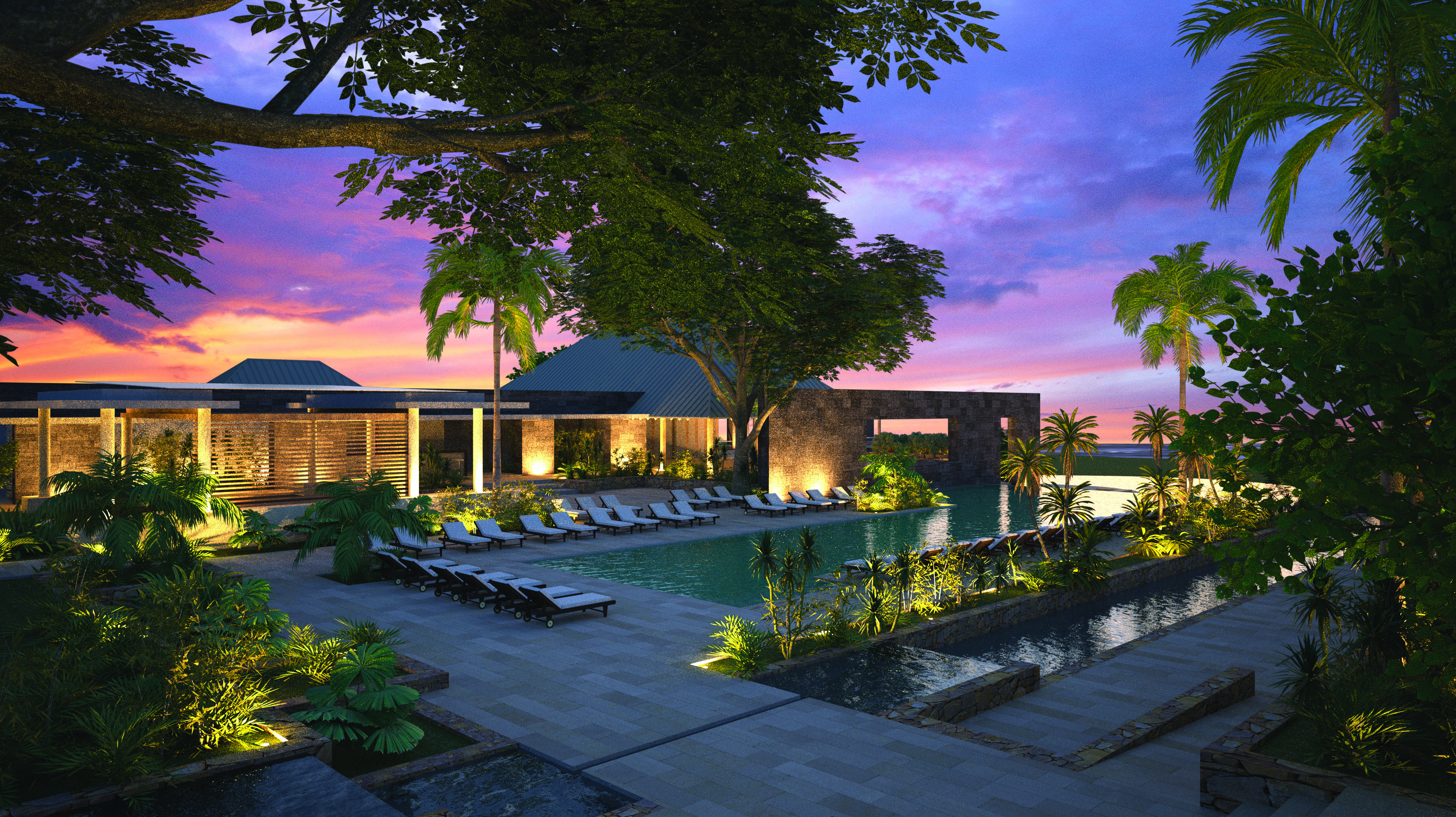 Outdoor swimming pool shown with sun loungers around the pool edge and a pink sunset in the sky 
