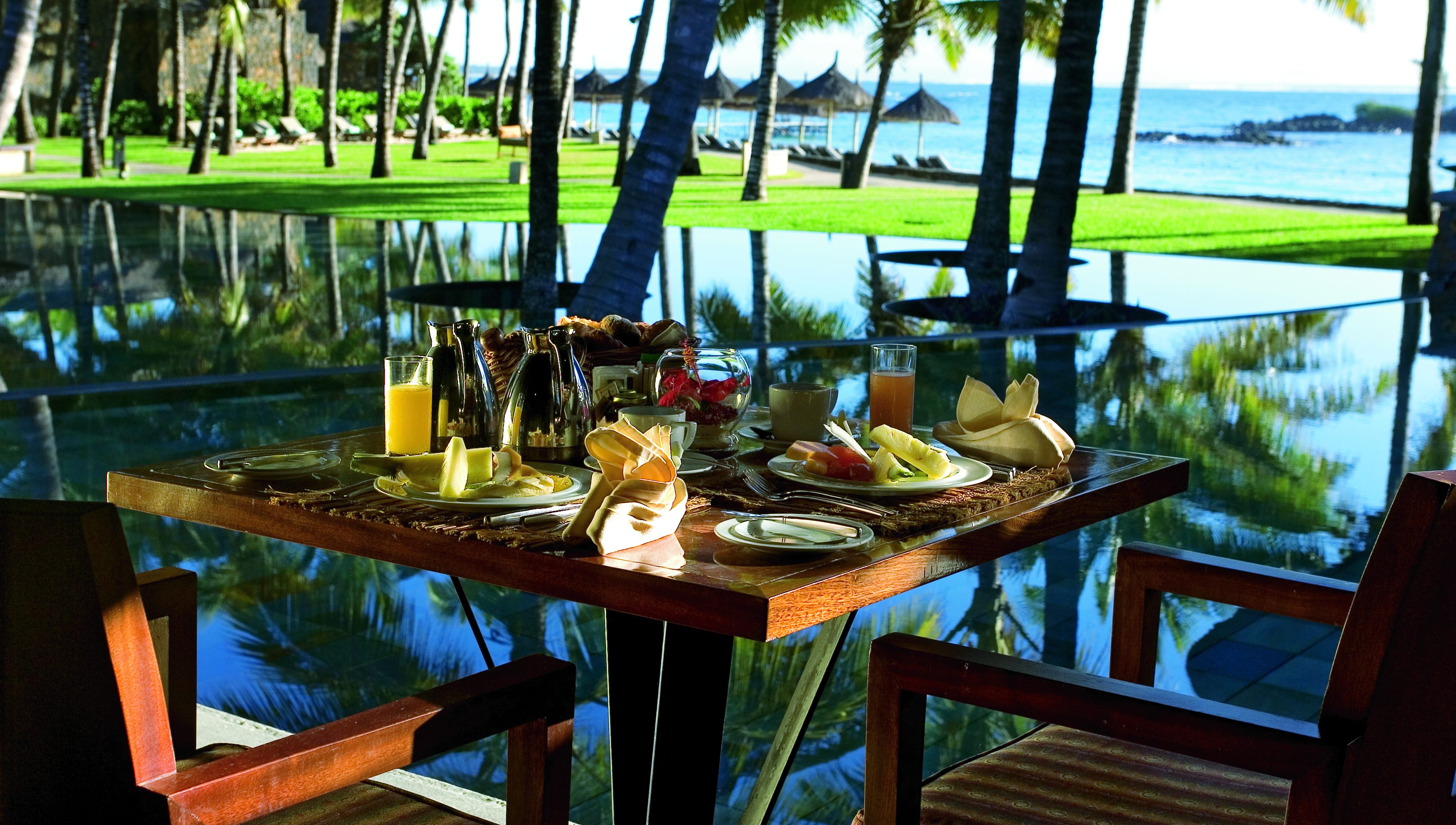 Constance Belle Mare Plage Mauritius table set for breakfast fresh fruit ocean views