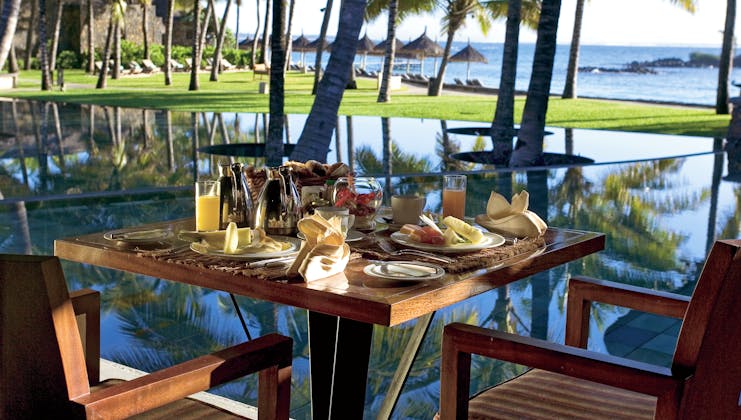 Constance Belle Mare Plage Mauritius table set for breakfast fresh fruit ocean views