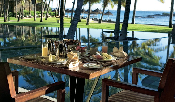 Constance Belle Mare Plage Mauritius table set for breakfast fresh fruit ocean views
