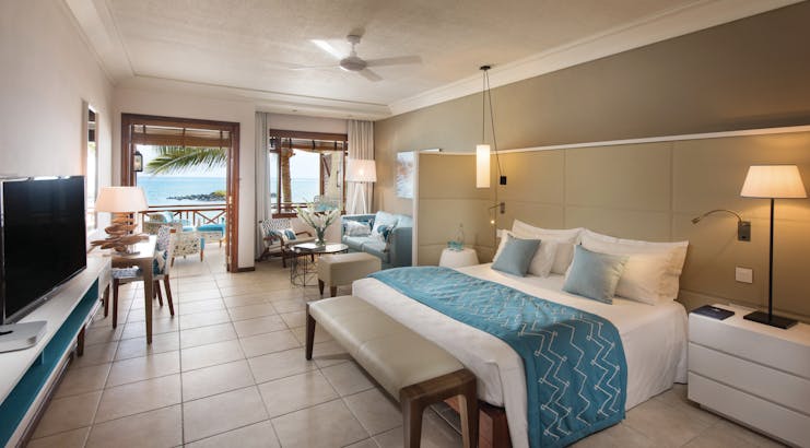 Constance Belle Mare Plage Mauritius junior suite bed lounge area modern décor sea views