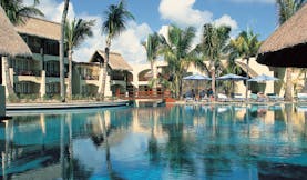 Constance Belle Mare Plage Mauritius poolside sun loungers umbrellas palm trees