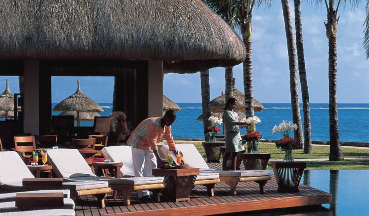 Constance Belle Mare Plage Mauritius terrace sun loungers overlooking pool