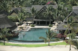 Constance Le Prince Maurice Mauritius pool sun loungers umbrellas palm trees