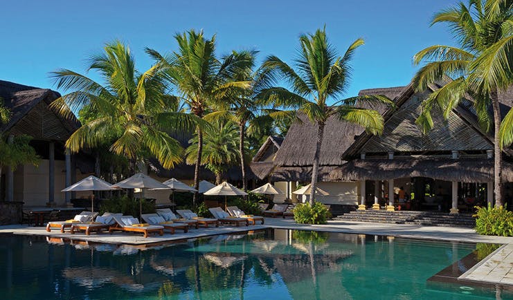 Constance Le Prince Maurice Mauritius poolside sun loungers umbrellas palm trees