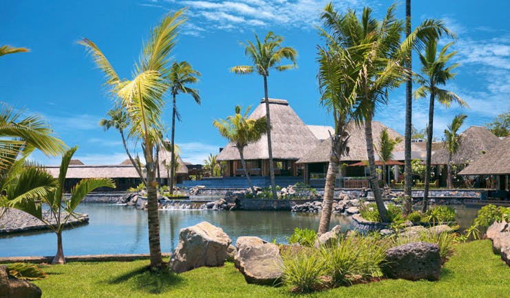 Four Seasons Mauritius exterior bungalows thatched rooves waterfront palm trees