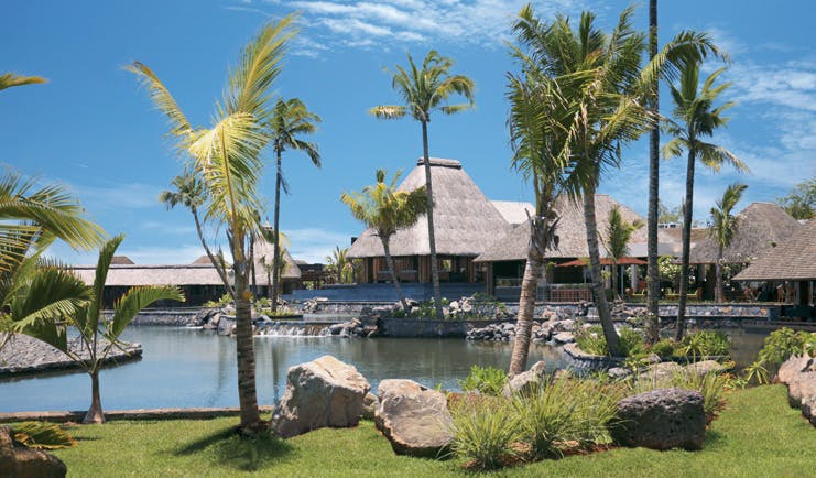 Four Seasons Mauritius exterior bungalows thatched rooves waterfront palm trees
