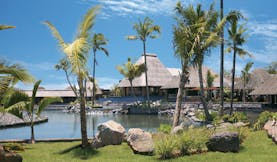 Four Seasons Mauritius exterior bungalows thatched rooves waterfront palm trees