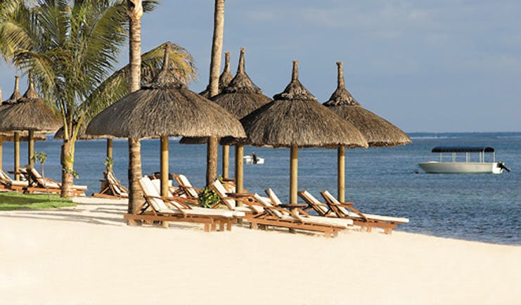 Le Telfair Mauritius beach sun beds umbrellas white sand ocean