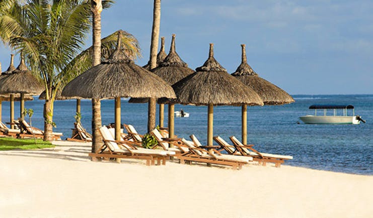 Le Telfair Mauritius beach sun beds umbrellas white sand ocean