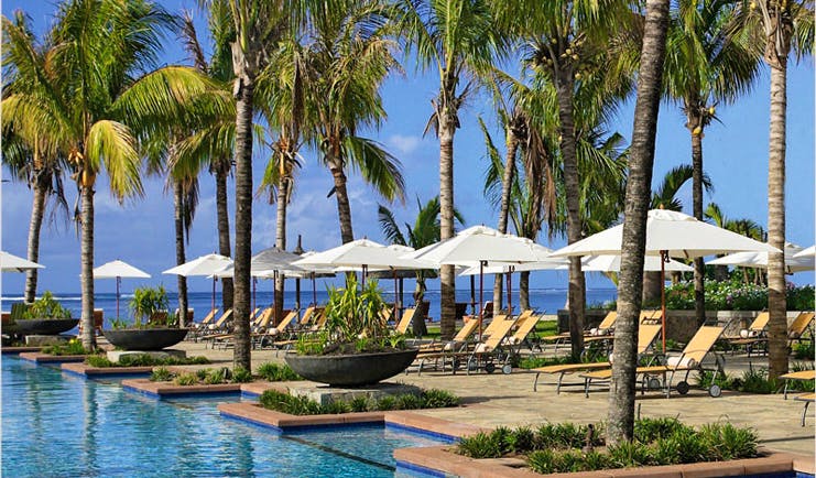 Le Telfair Mauritius poolside sun loungers umbrellas palm trees
