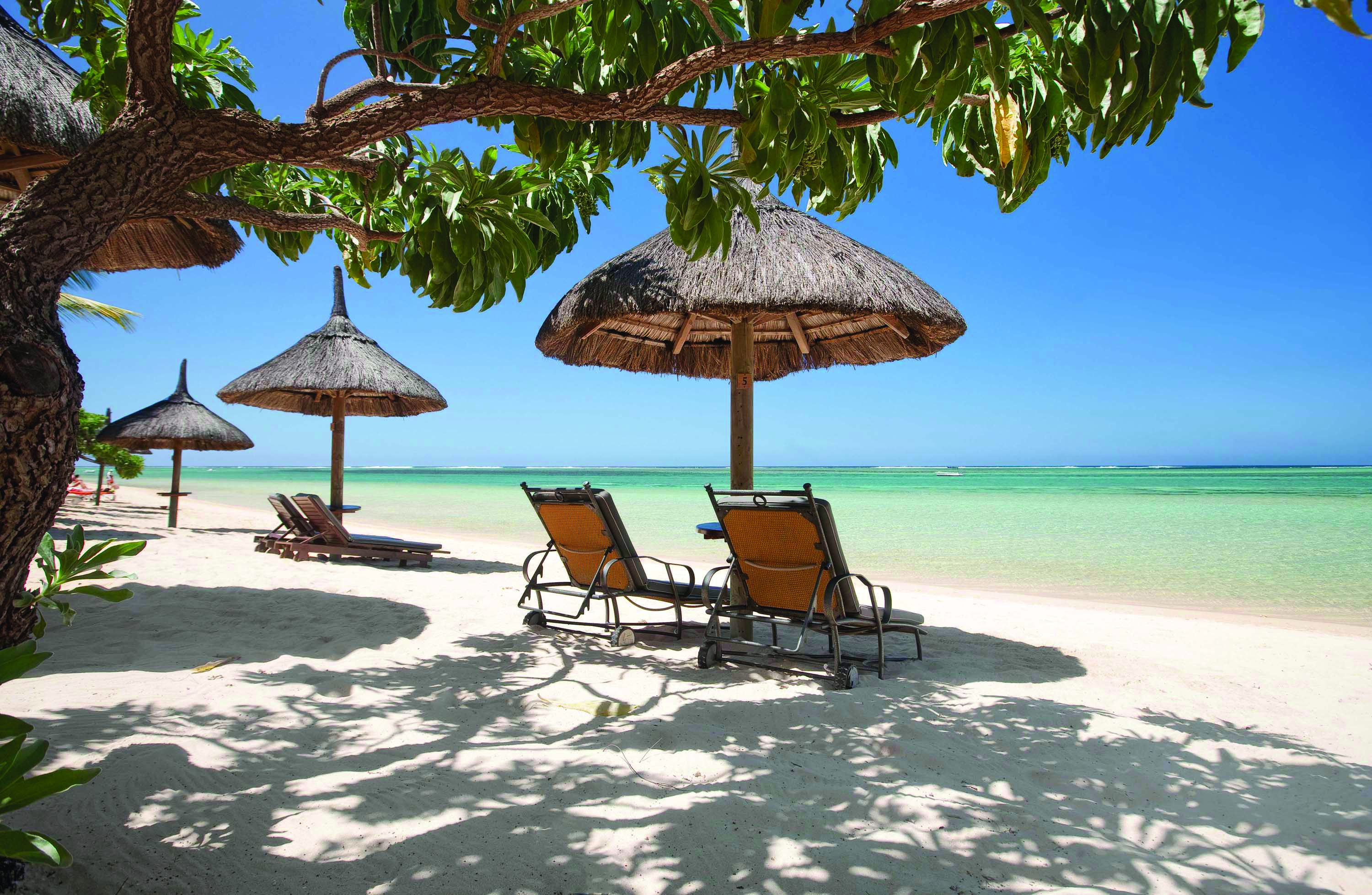 Heritage the Villas Mauritius beach sun loungers umbrellas white sands blue sea