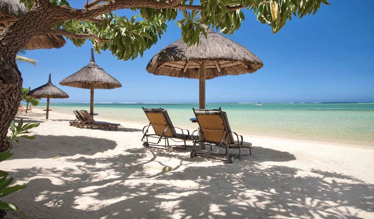 Heritage the Villas Mauritius beach sun loungers umbrellas white sands blue sea
