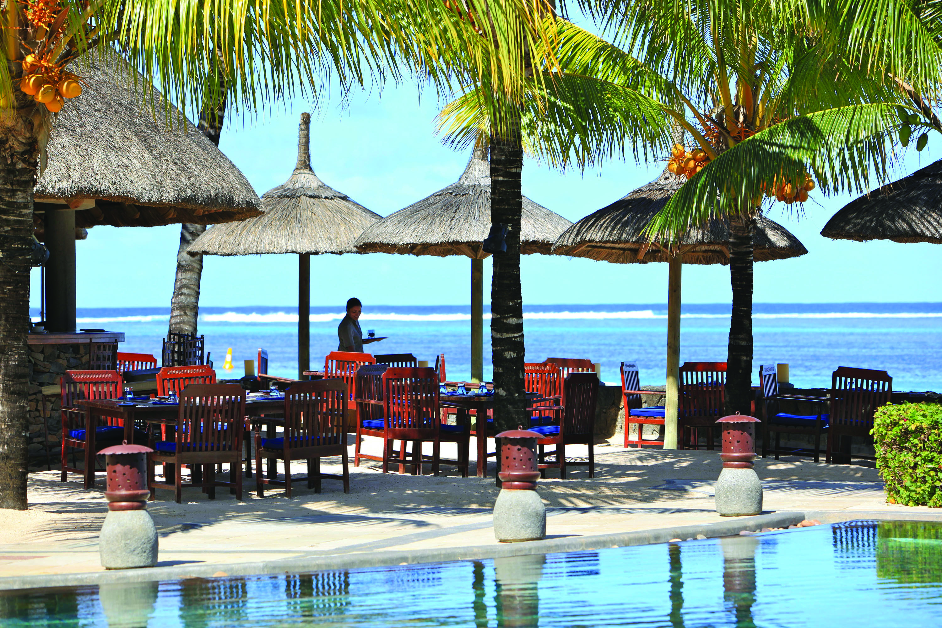 Heritage the Villas Mauritius poolside seating area overlooking sea