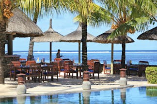 Heritage the Villas Mauritius poolside seating area overlooking sea