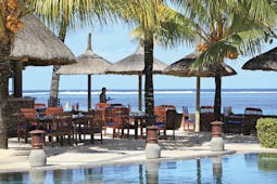 Heritage the Villas Mauritius poolside seating area overlooking sea
