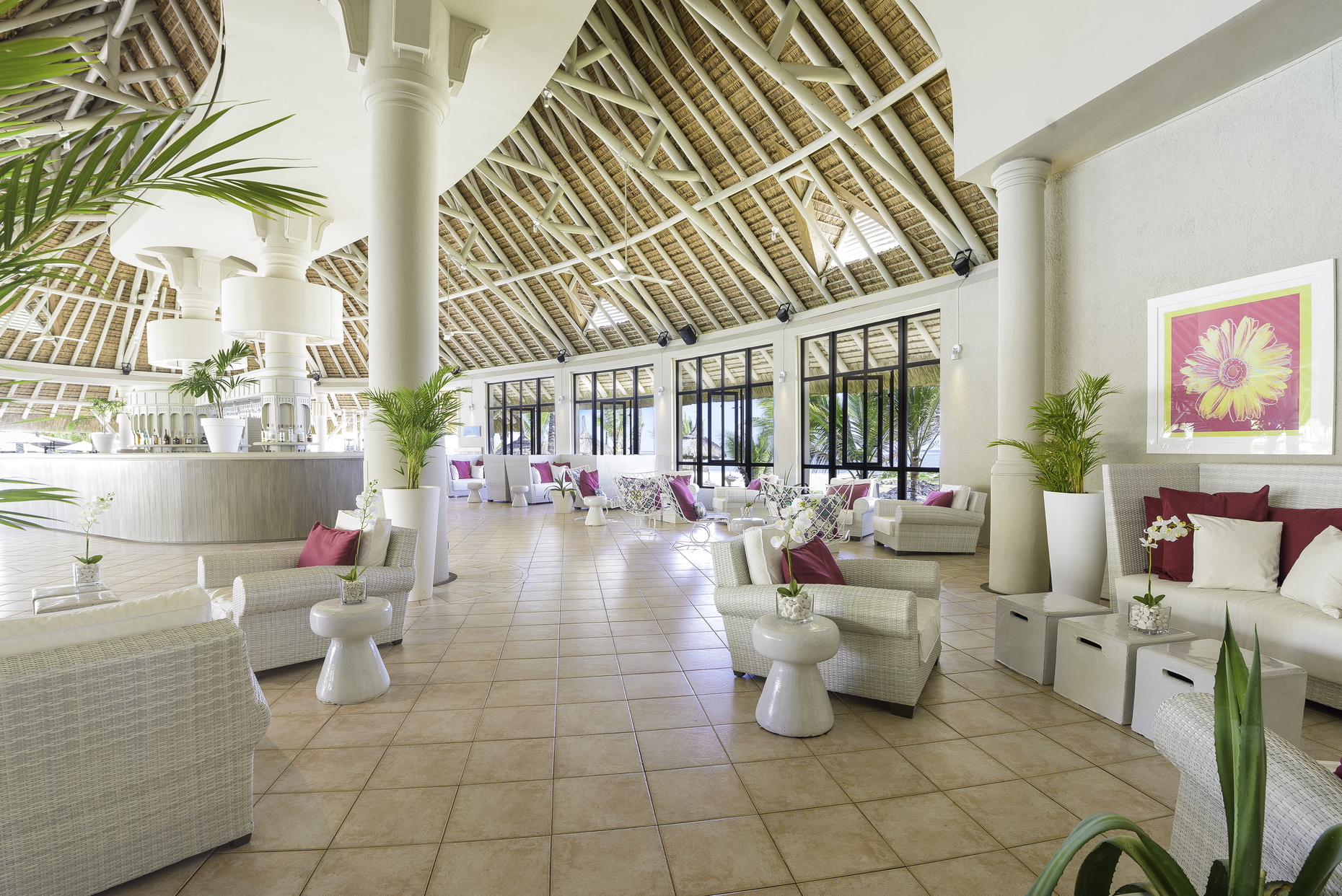 Bar with seating areas and plants around the room
