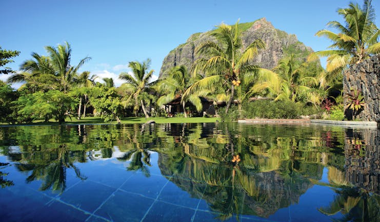 Lux Le Morne Mauritius gardens lawn palm trees mountain in background pool