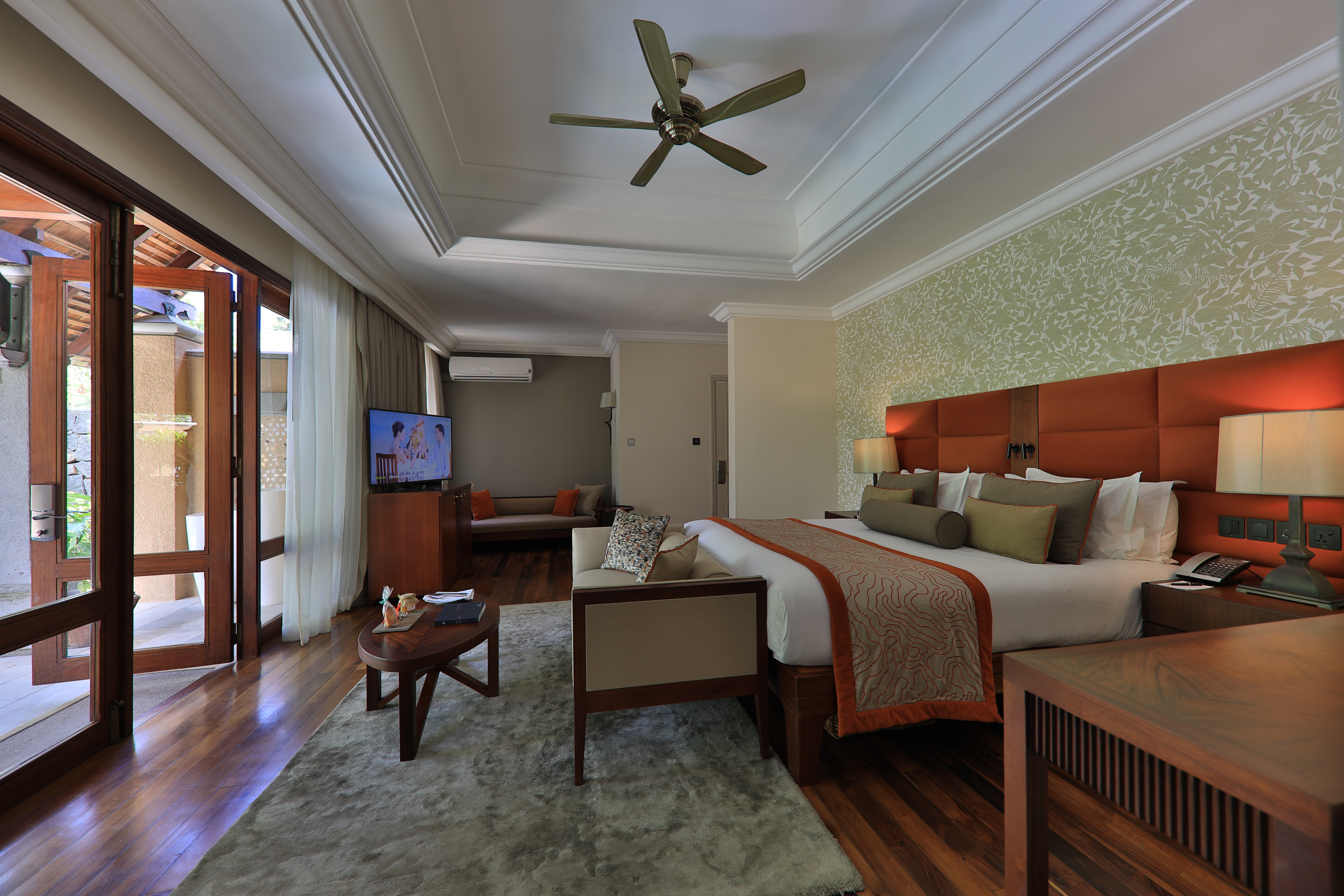 Beachfront suite pool villa bedroom with double bed and electric fan 