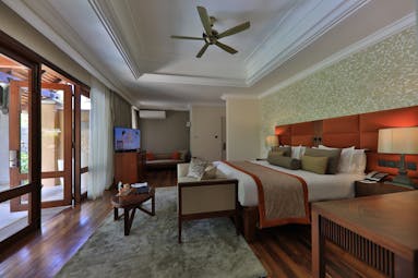Beachfront suite pool villa bedroom with double bed and electric fan 