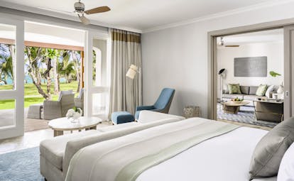 Beach front suite room with large double bed, terrace balcony opening onto the beach and living space