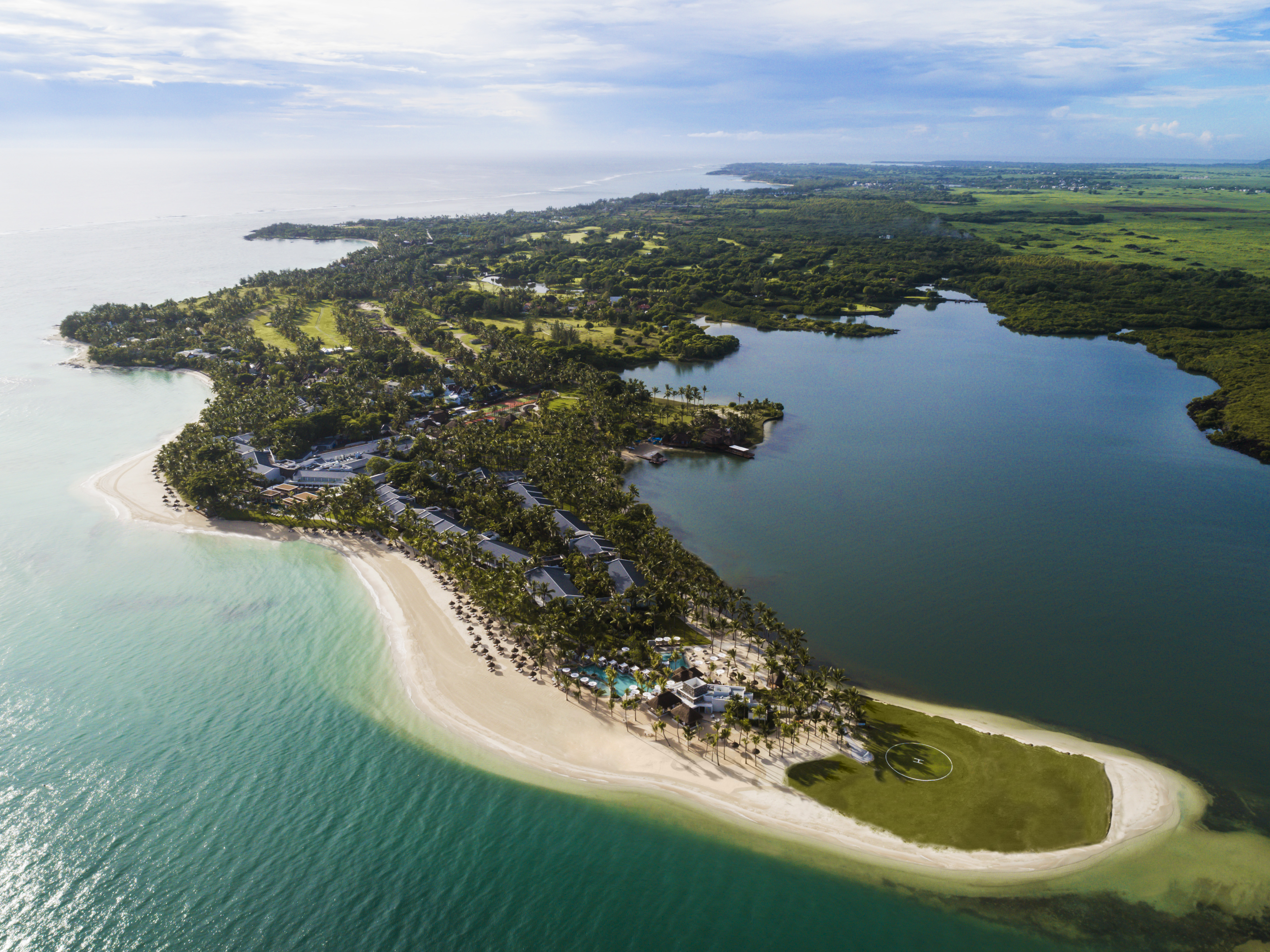 Aerial view of resort island with sandy beaches shown along the coast