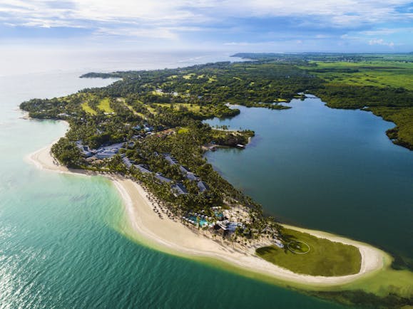 Aerial view of resort island with sandy beaches shown along the coast