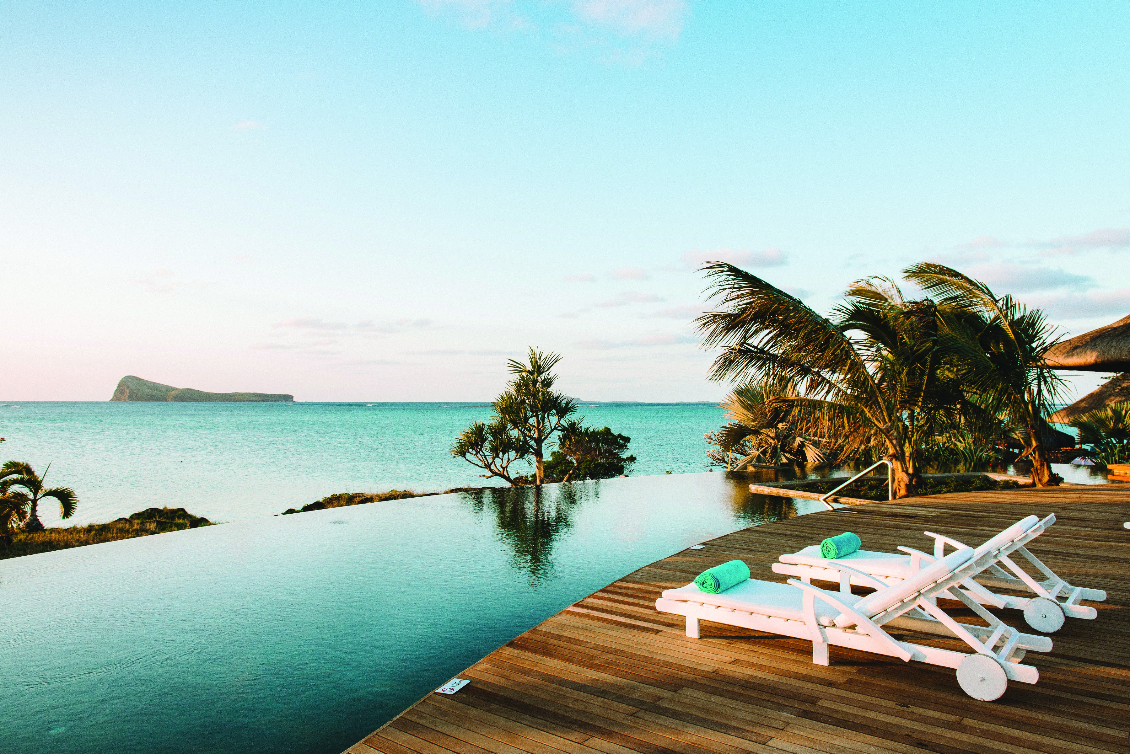 Paradise Cove infinity pool, decking, sun loungers, palm trees, overlooking sea