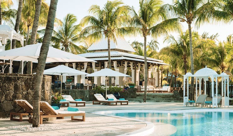 Paradise Cove swimming pool, sun loungers, umbrellas, palm trees