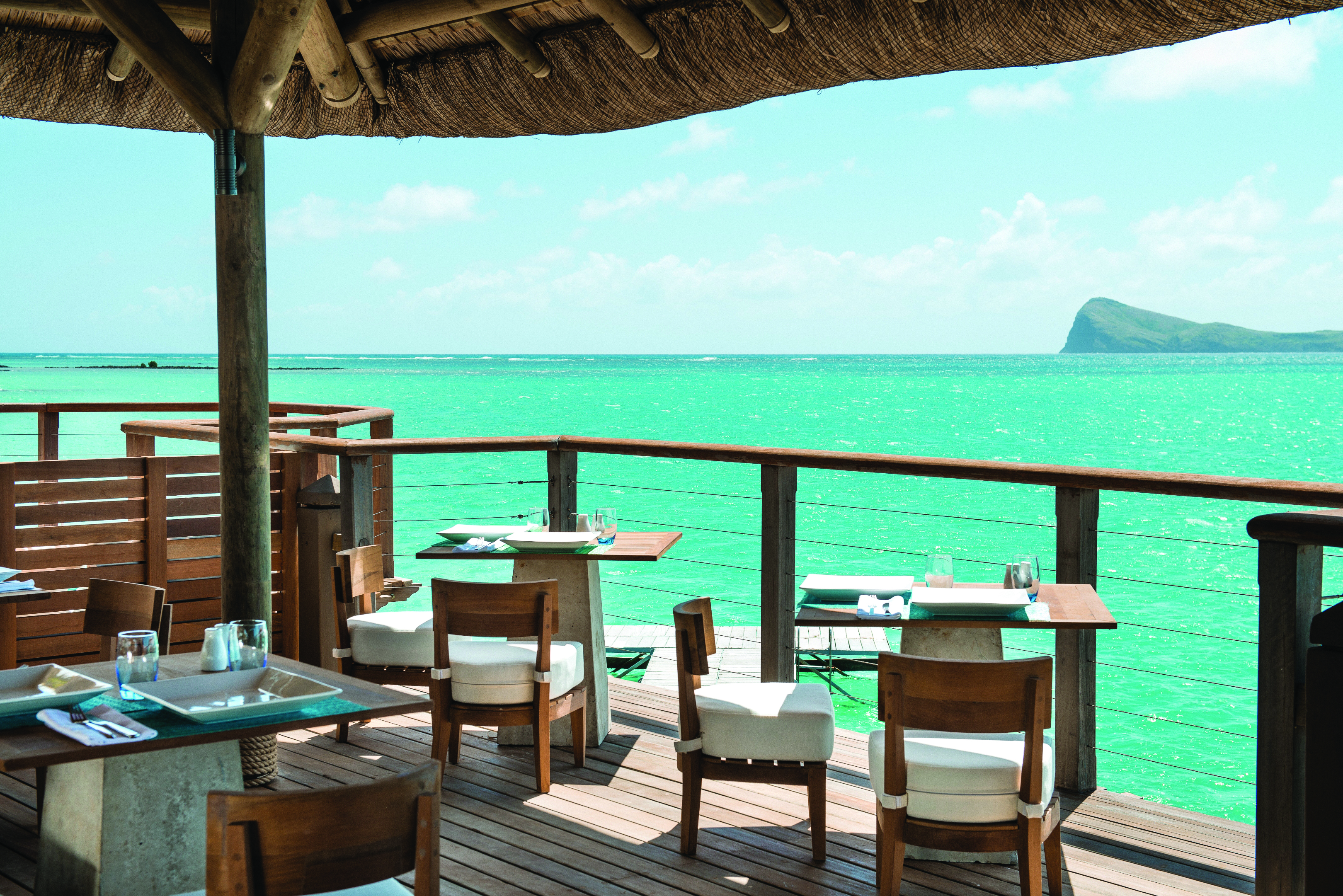 Paradise Cove restaurant, tables and chairs, on covered decking overlooking sea